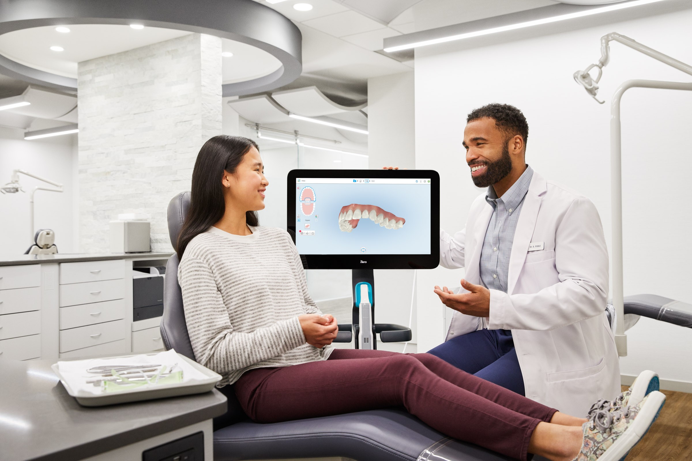 Dentist showing a teenager her iTero scan